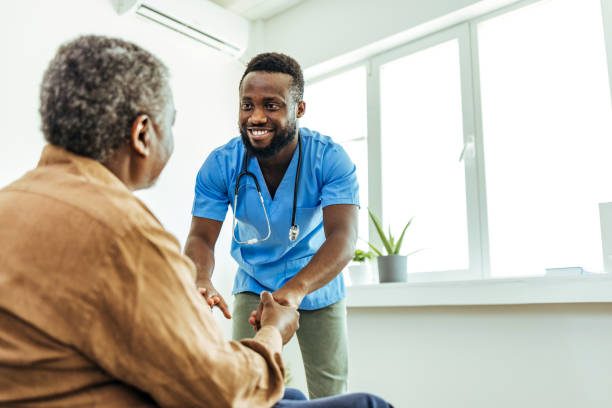 A nurse greeting an older patient at home.